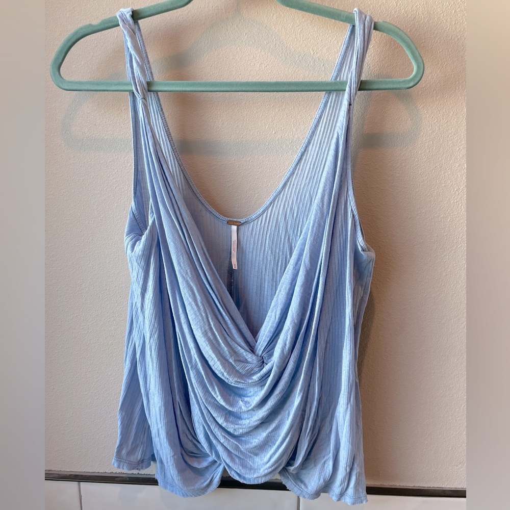 Free People. Light blue loose fitting tank. Raw hem. Size M